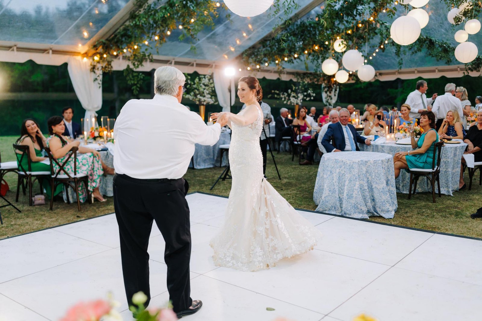 All white dance floor set up under a tent at an outdoor Los Angeles wedding reception